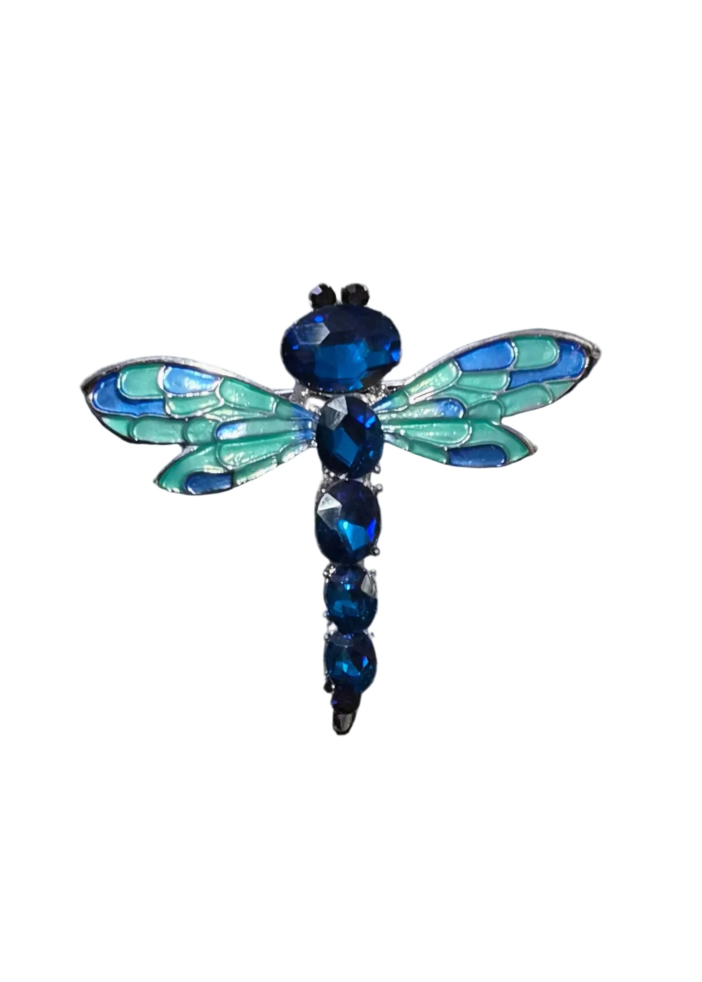 A close-up of a dragonfly brooch in iridescent blue-green and dark blue crystals.