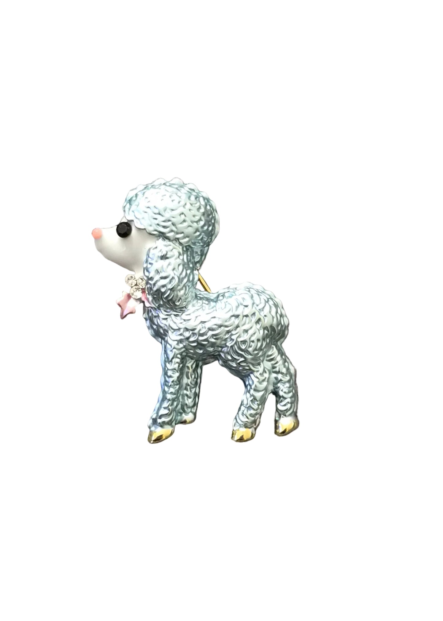 A small poodle-shaped brooch with textured silver-blue enamel, a white face, and gold-toned claws.