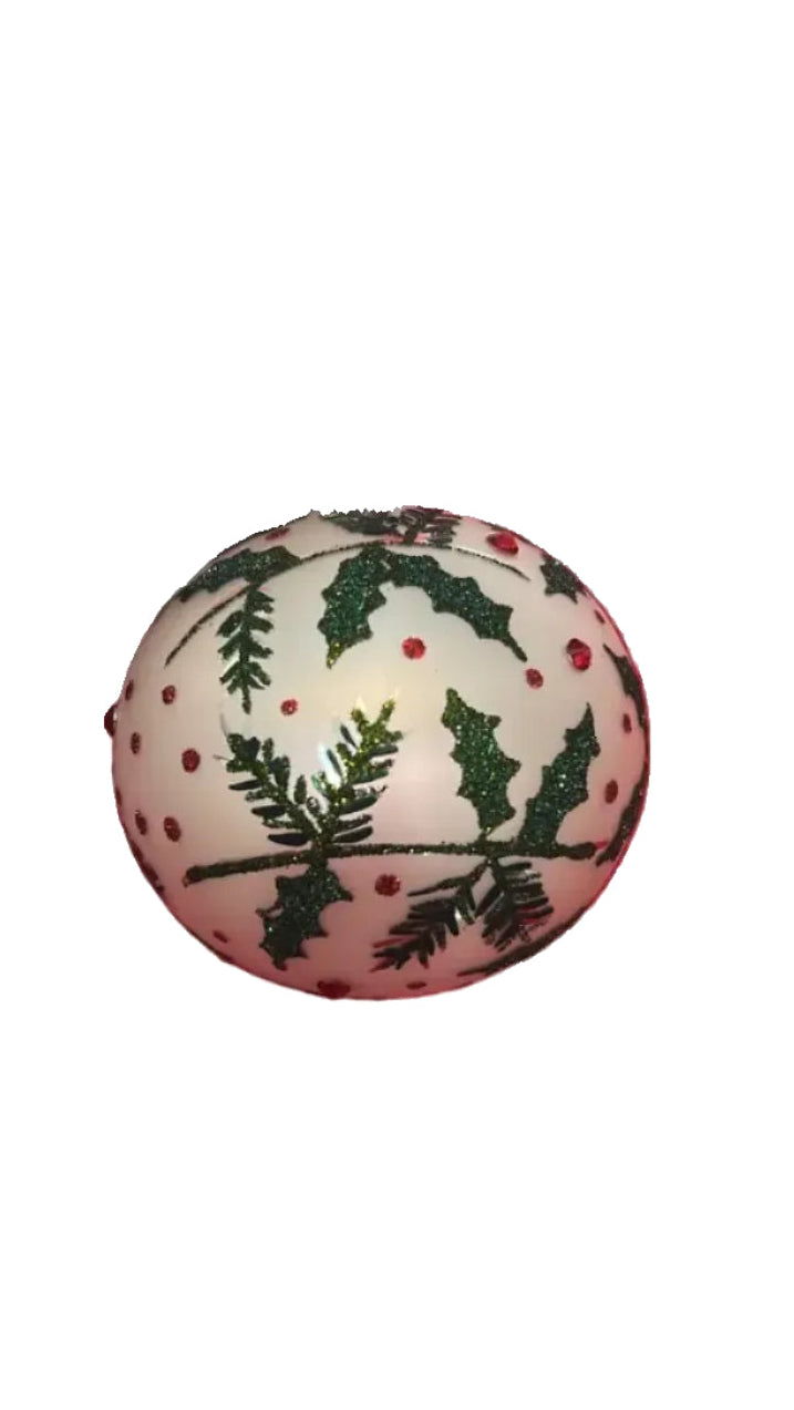 Decorative round item with holly design on a white background