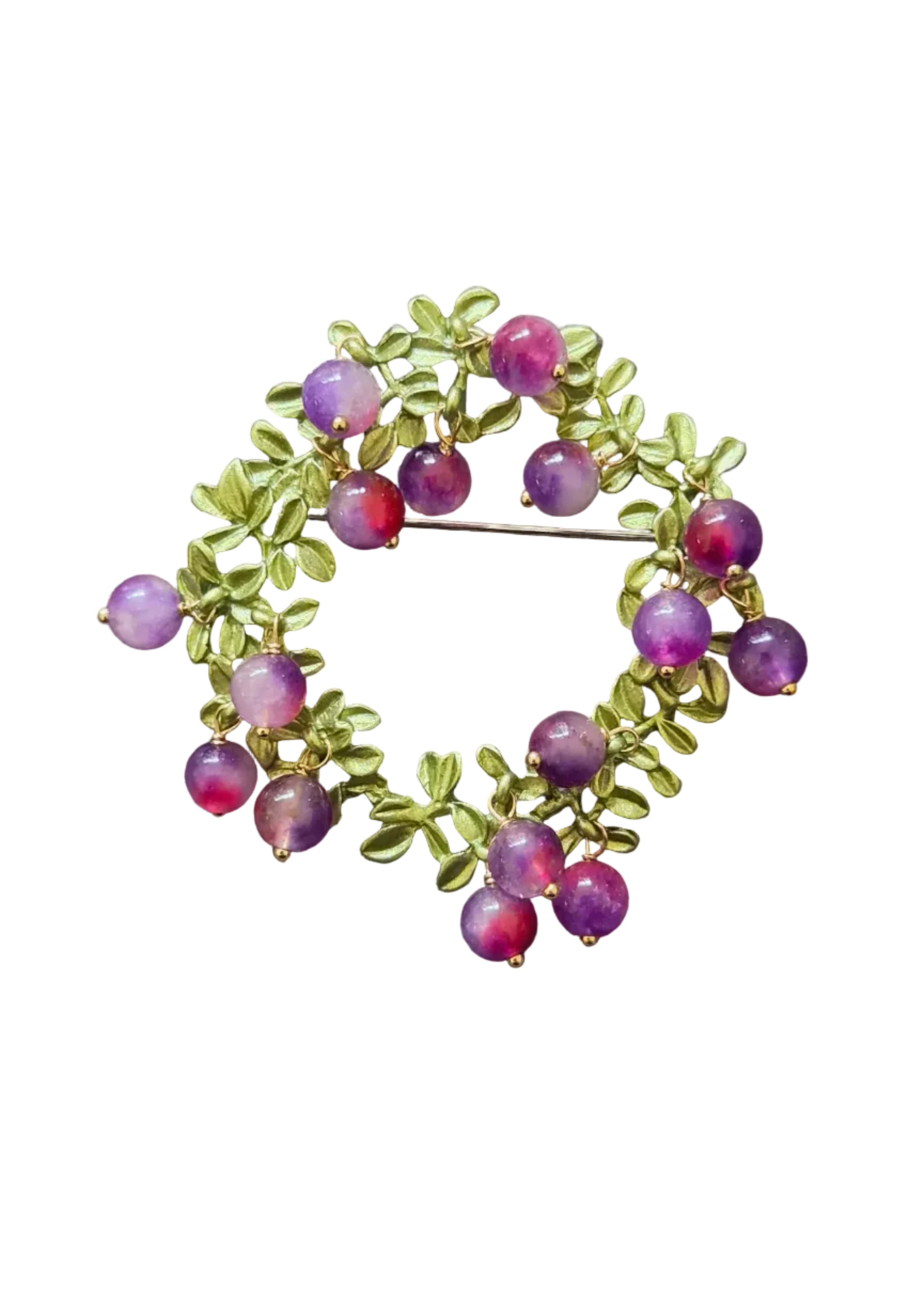 A gold-toned brooch featuring green leaf motifs and small round purple beads.