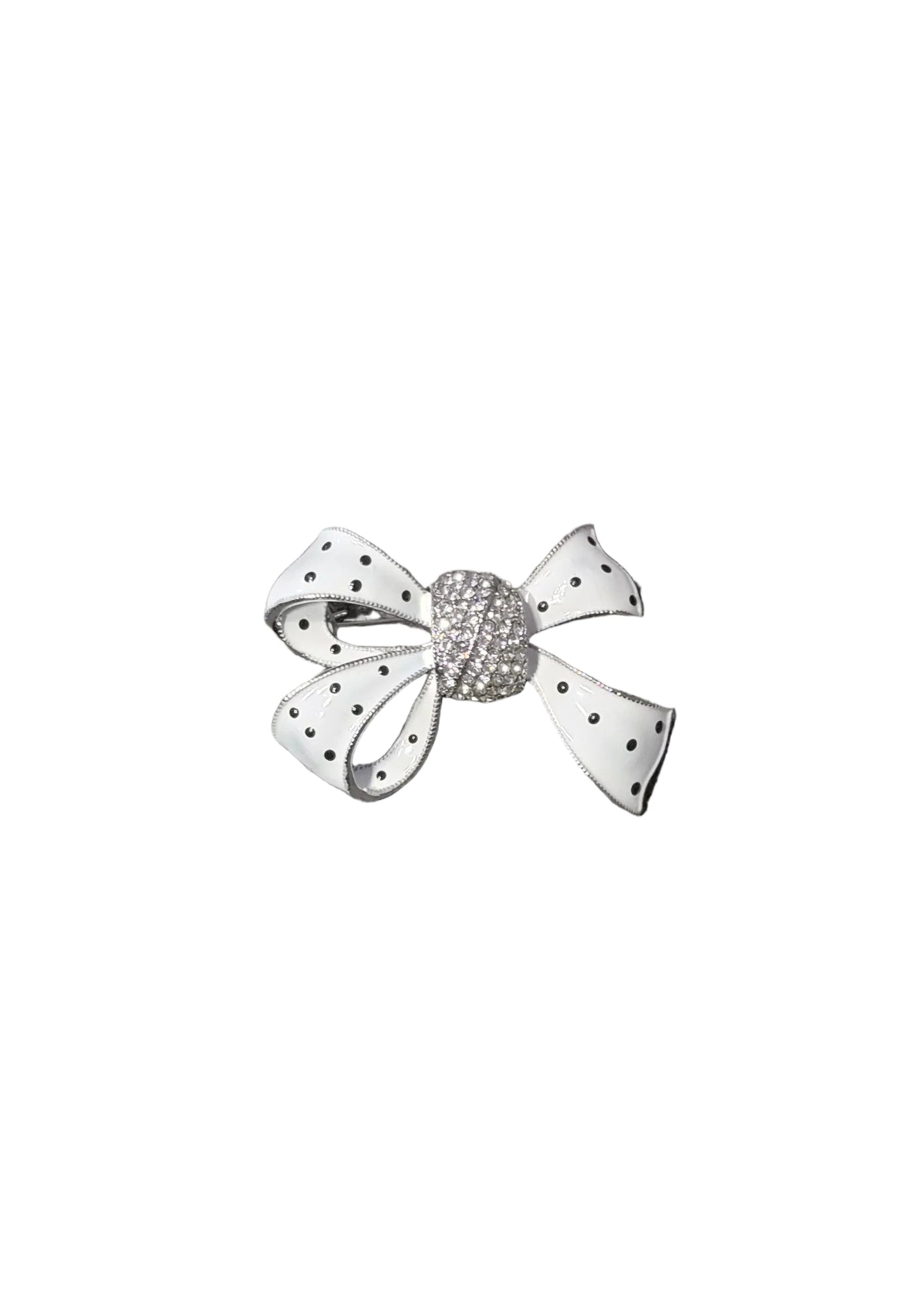A small bow-shaped brooch with white fabric-like petals and black polka dots