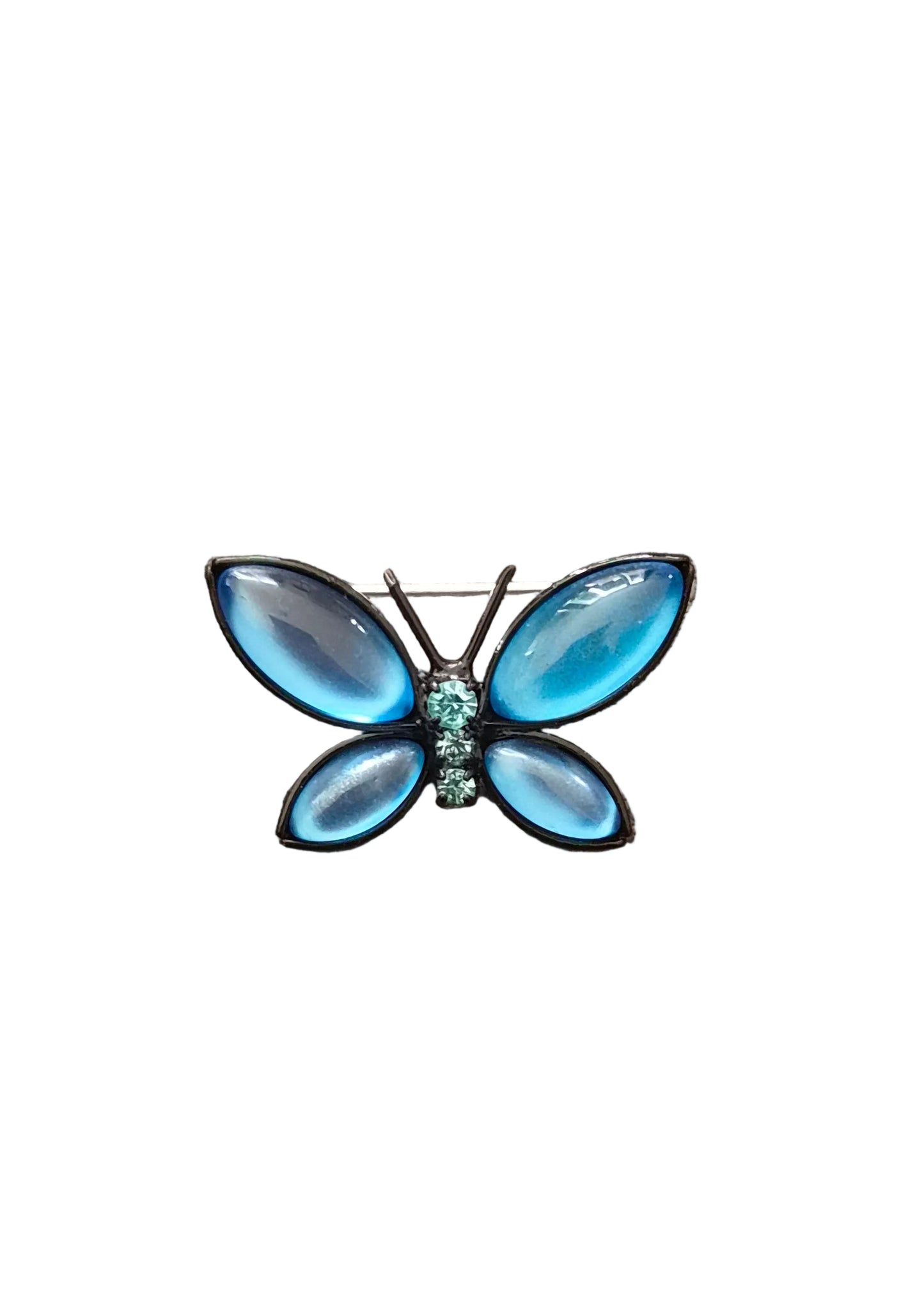 A butterfly-shaped brooch with iridescent light blue wings and a small turquoise center.