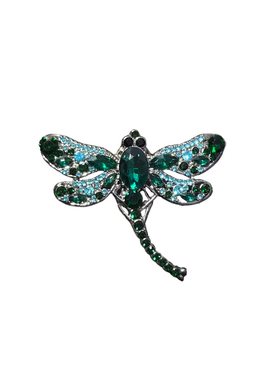 A dragonfly-shaped brooch with green and blue rhinestones