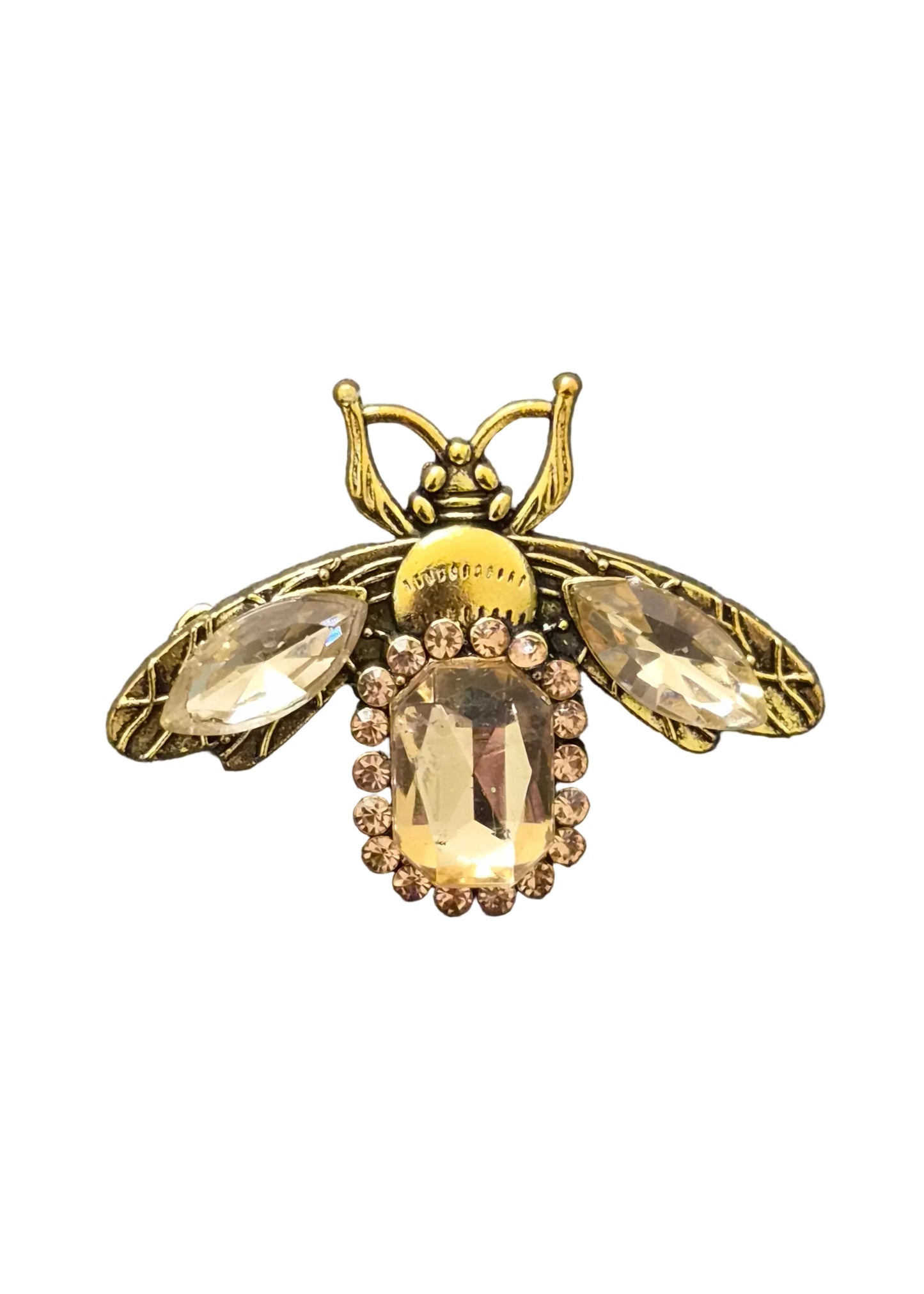 A vintage-style gold bumblebee brooch featuring large clear rhinestone wings and a central oval clear rhinestone, surrounded by small clear crystals.