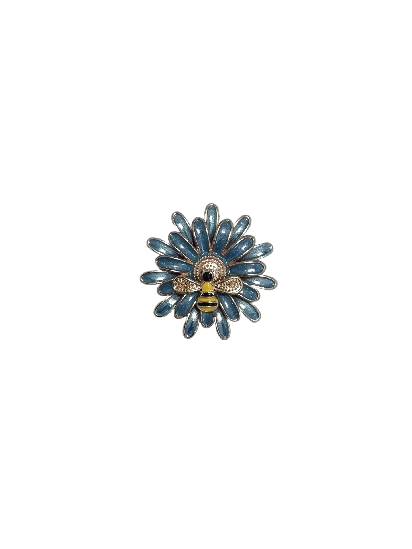 Decorative brooch with blue floral design and bee on a textured gray background