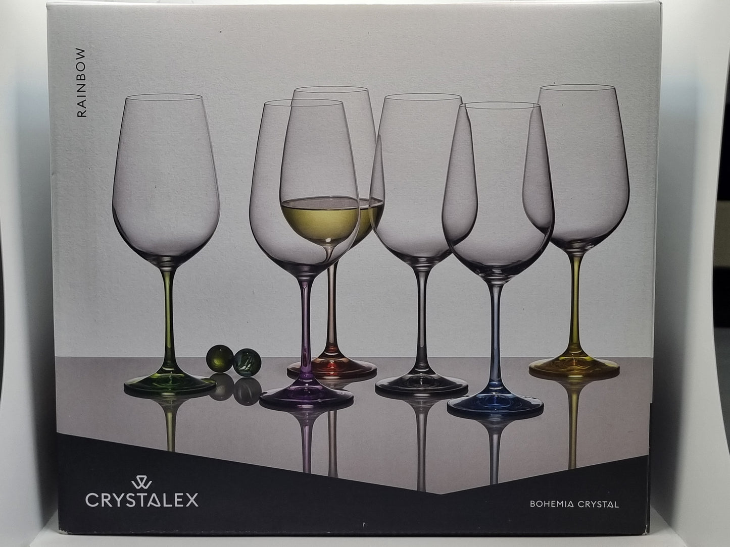 Box of Crystalex red wine glasses with a colourful design on a white background