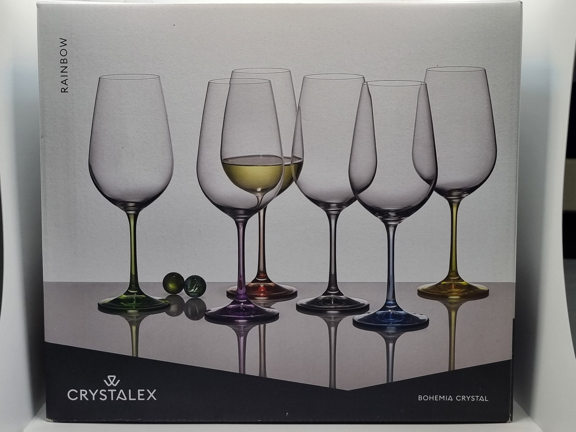 Box of Crystalex red wine glasses with a colourful design on a white background