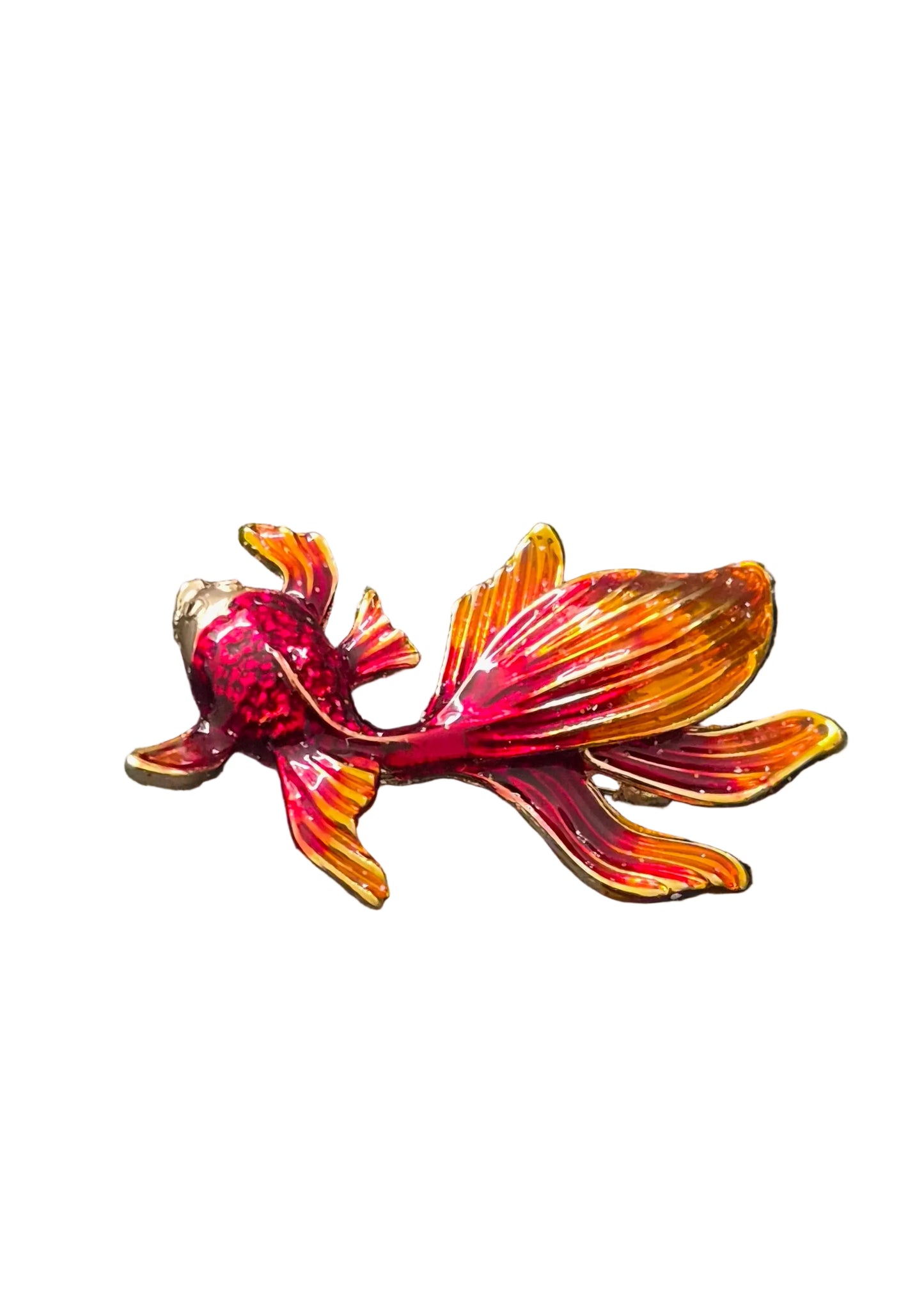 A goldfish-shaped brooch with red and orange enamel detailing and gold-toned metal outlines.