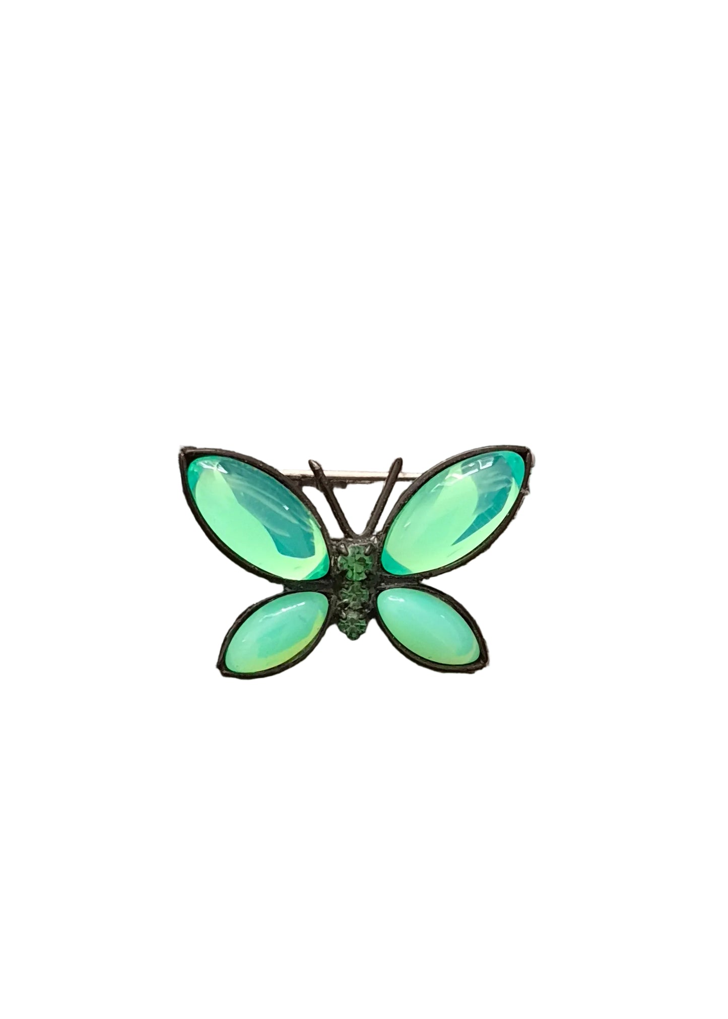 A butterfly-shaped brooch with four iridescent light green wings and a small green center.