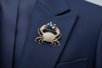 Gold crab-shaped brooch with gemstones on a navy blue suit jacket