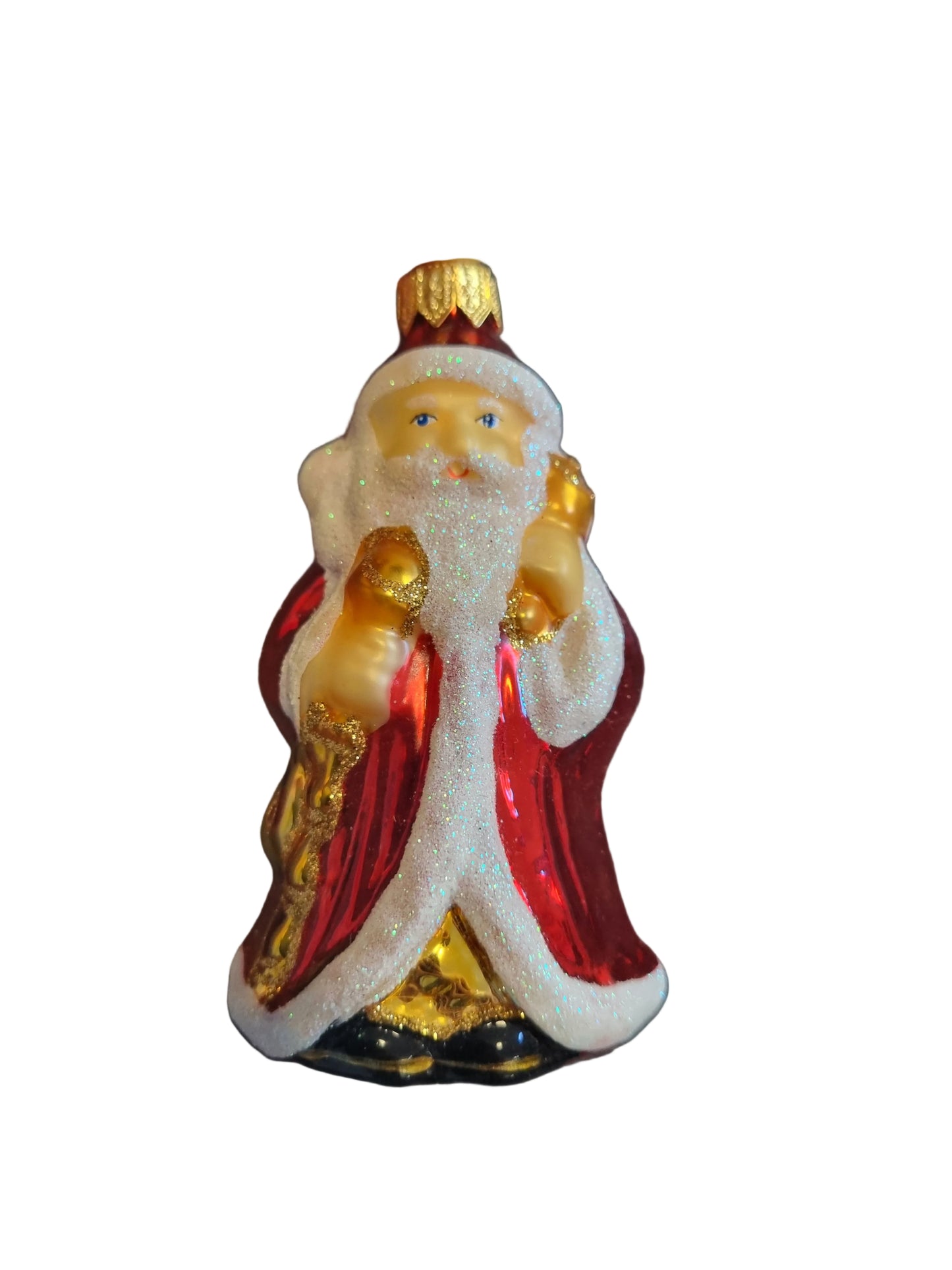 Hand holding a decorative Santa figurine with red and gold colors 