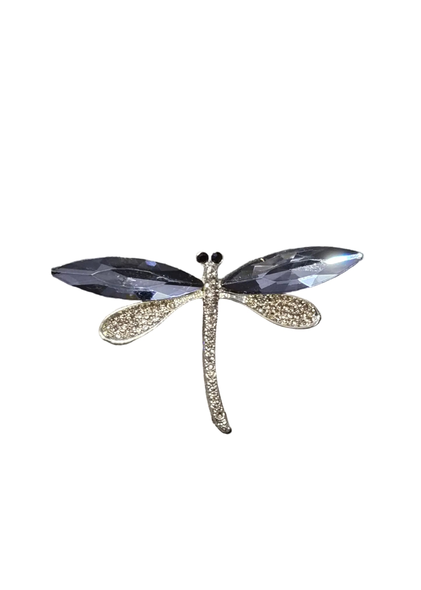 A dragonfly-shaped brooch with clear faceted wings and a textured gold body