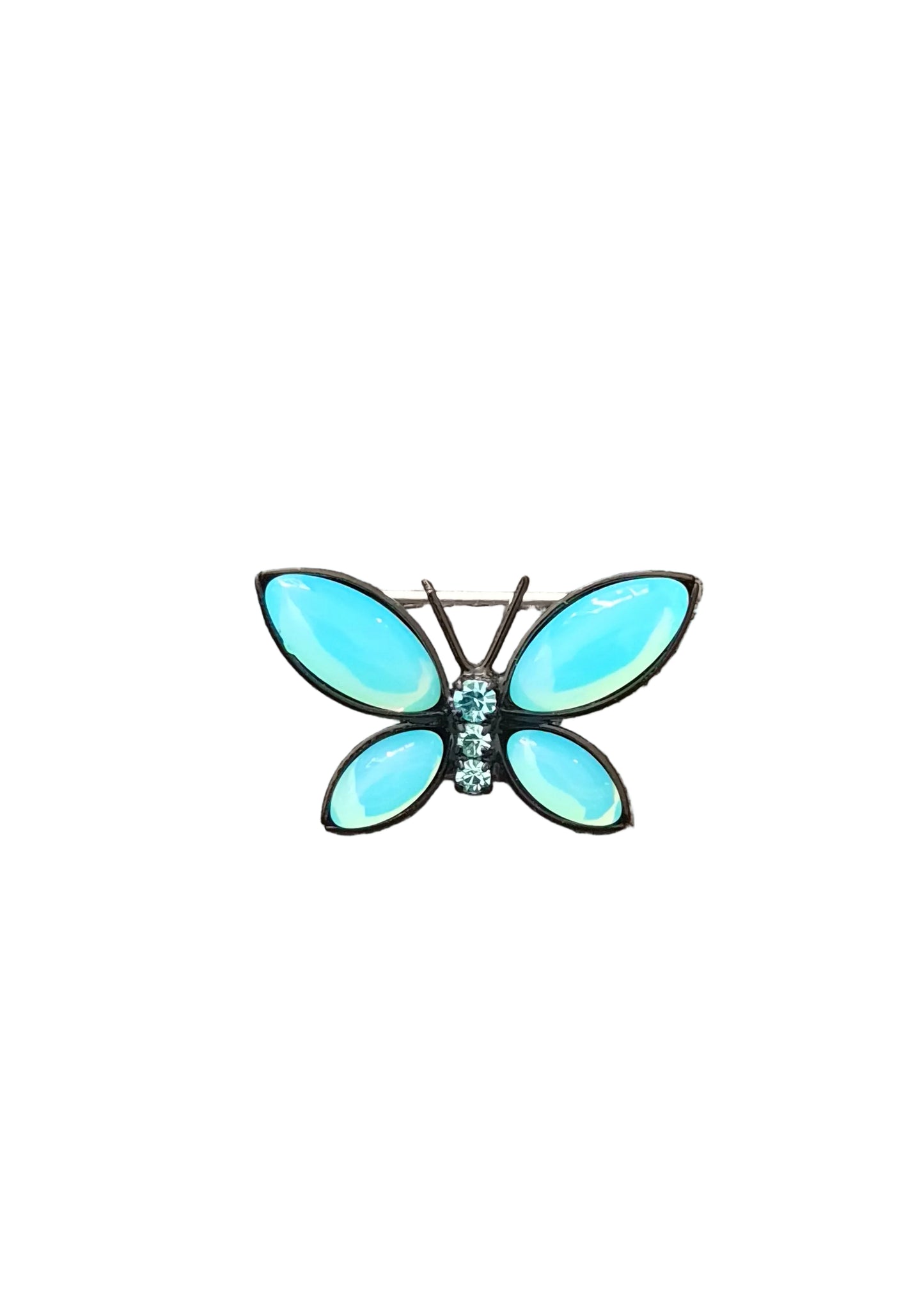A butterfly-shaped brooch with light blue opal-like wings and a small cluster of clear rhinestones at the center, set in silver-toned metal.